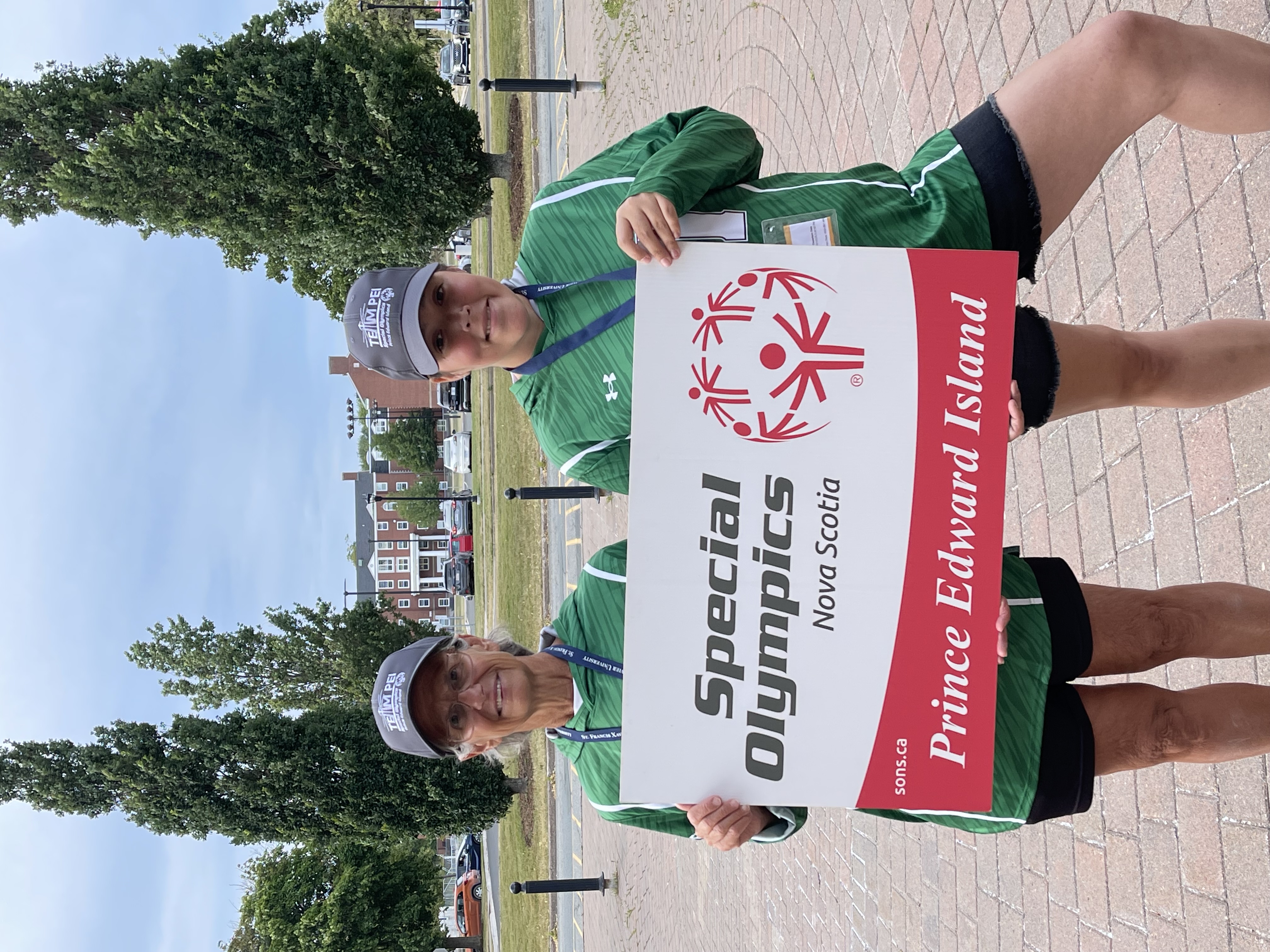Special Olympics PEI, Provincial Games, Athlete and Coach with Team PEI Sign