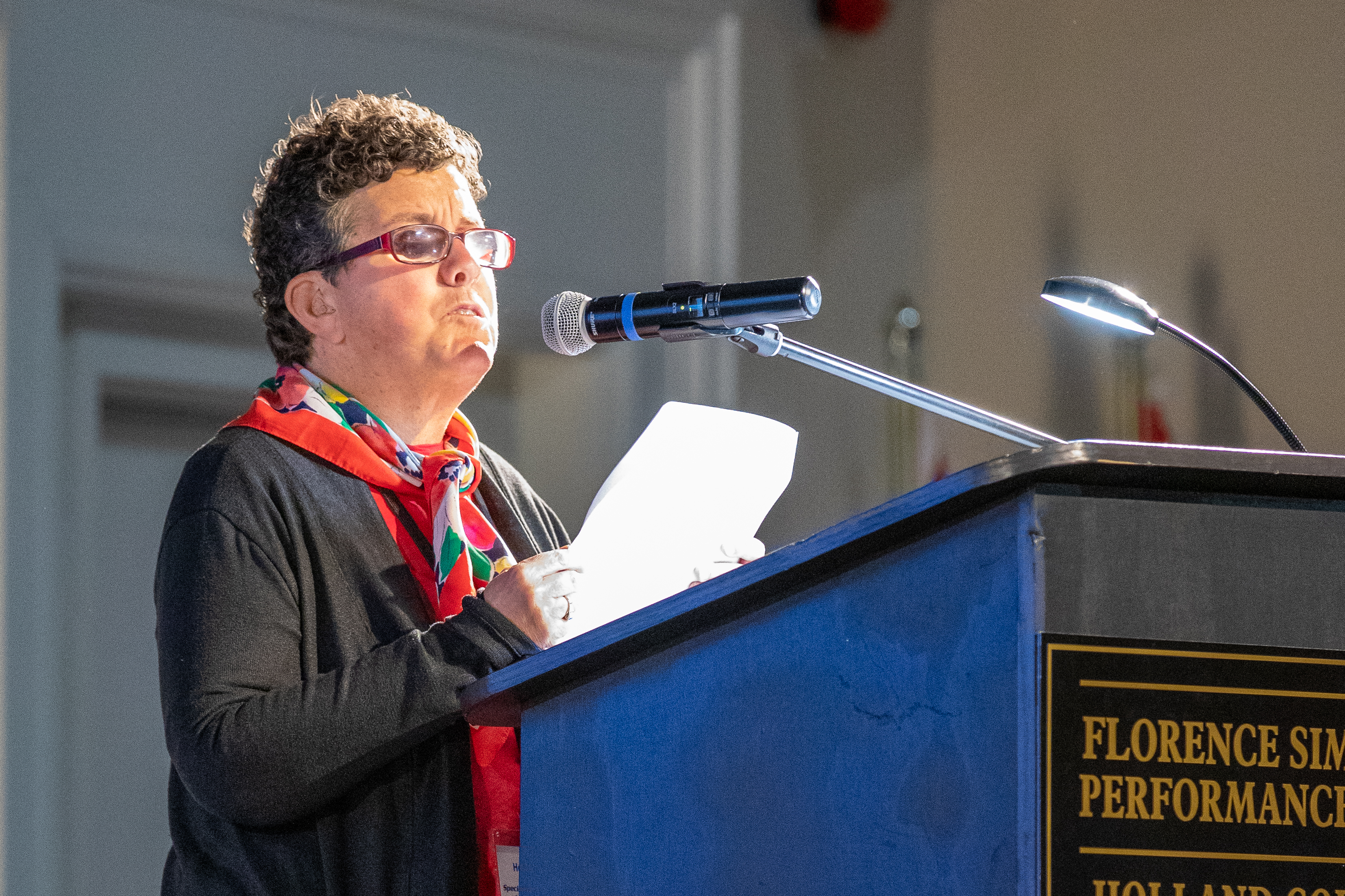 Athlete Leader, Heidi Mallett, speaking at a podium