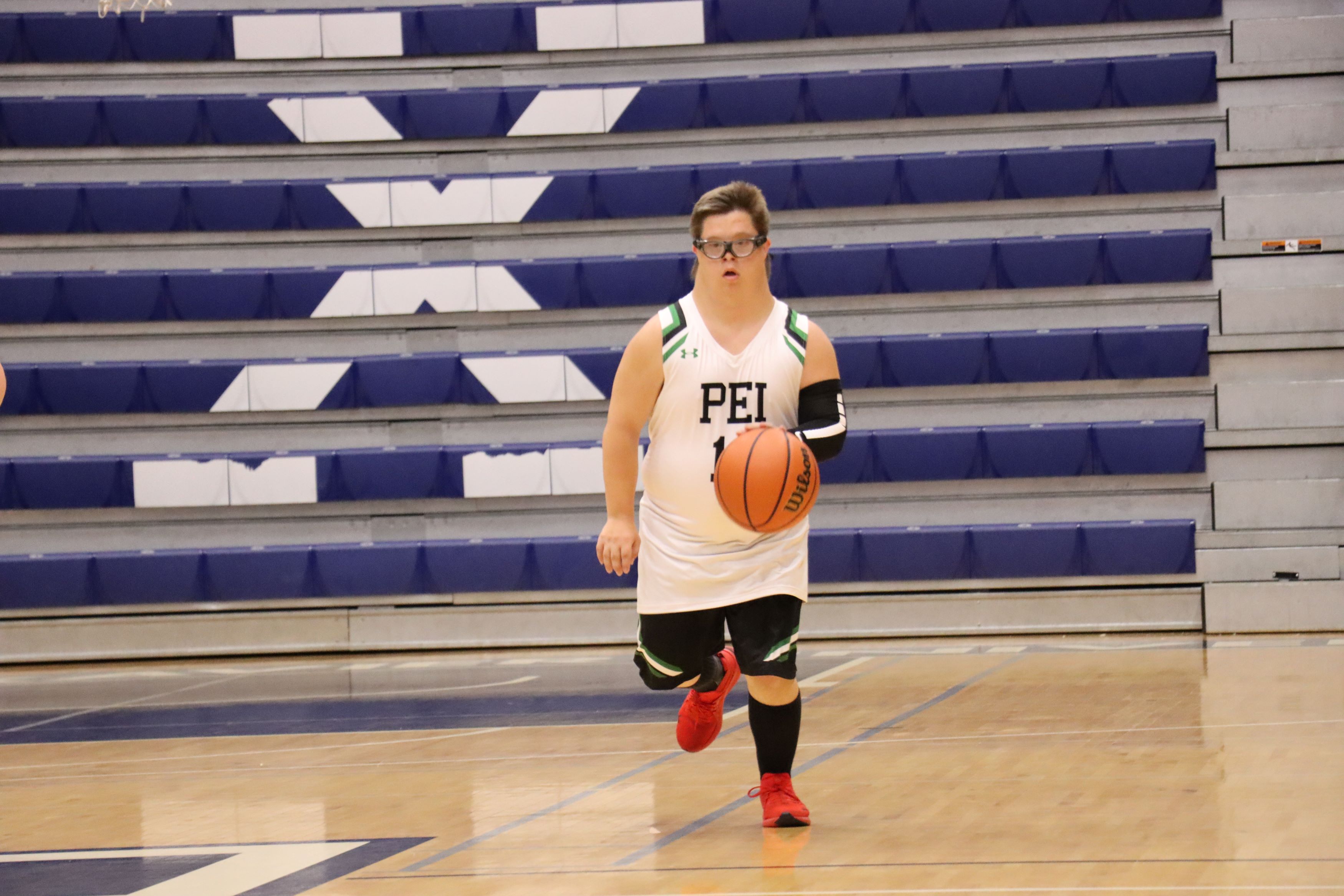 Team PEI 2026 Basketball athlete, Jacob MacNeill, dripples the basketball down the court