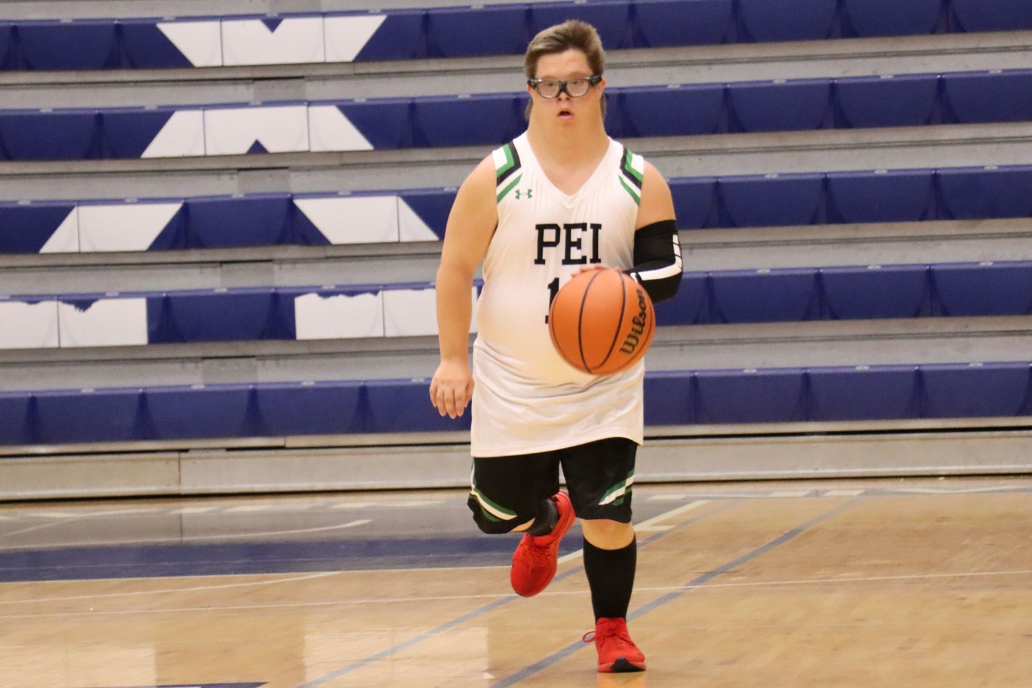 Team PEI 2026 Basketball athlete, Jacob MacNeill, dripples the basketball down the court