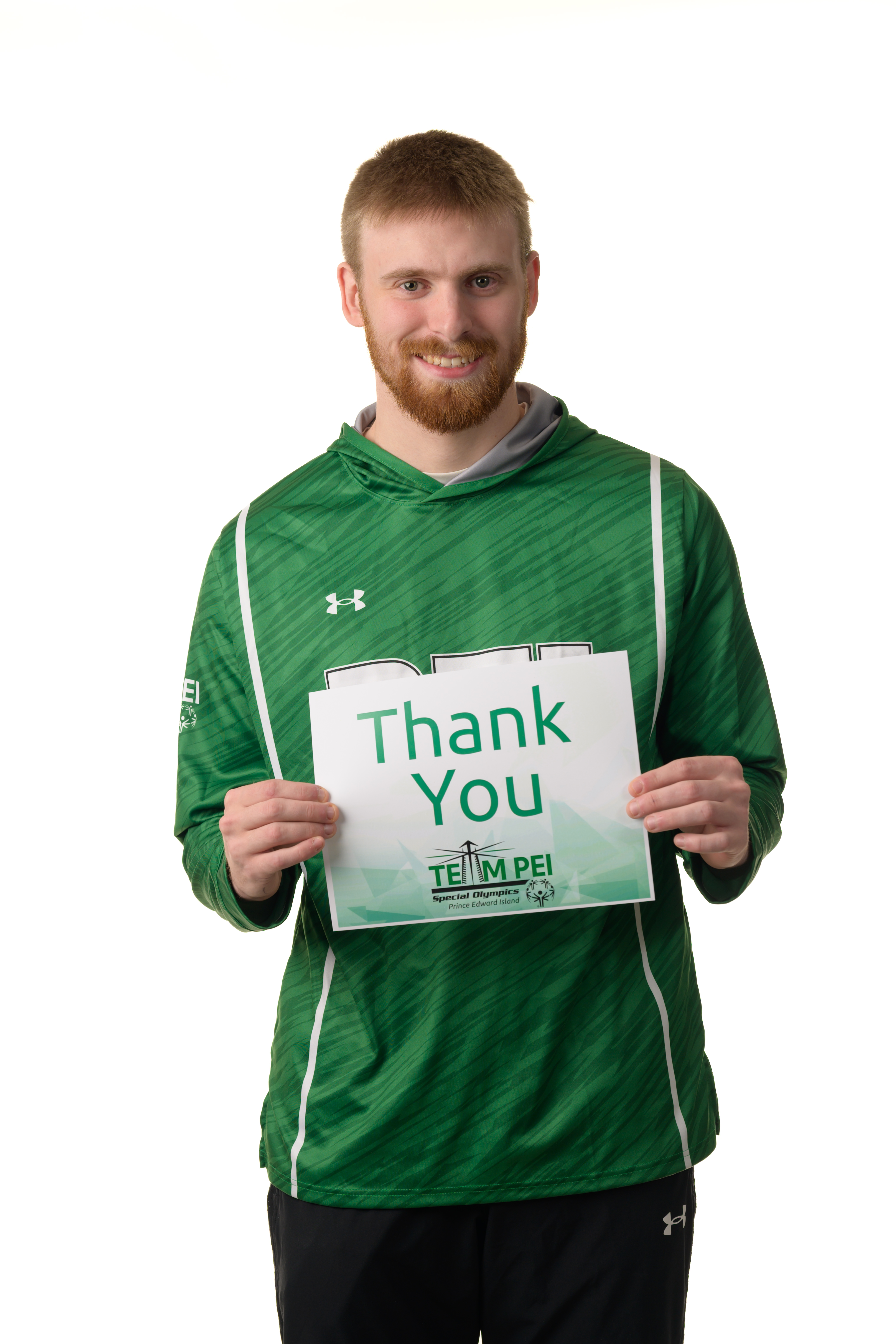 Team PEI 2026 athlete, Logan Robbins, standing with a thank you sign