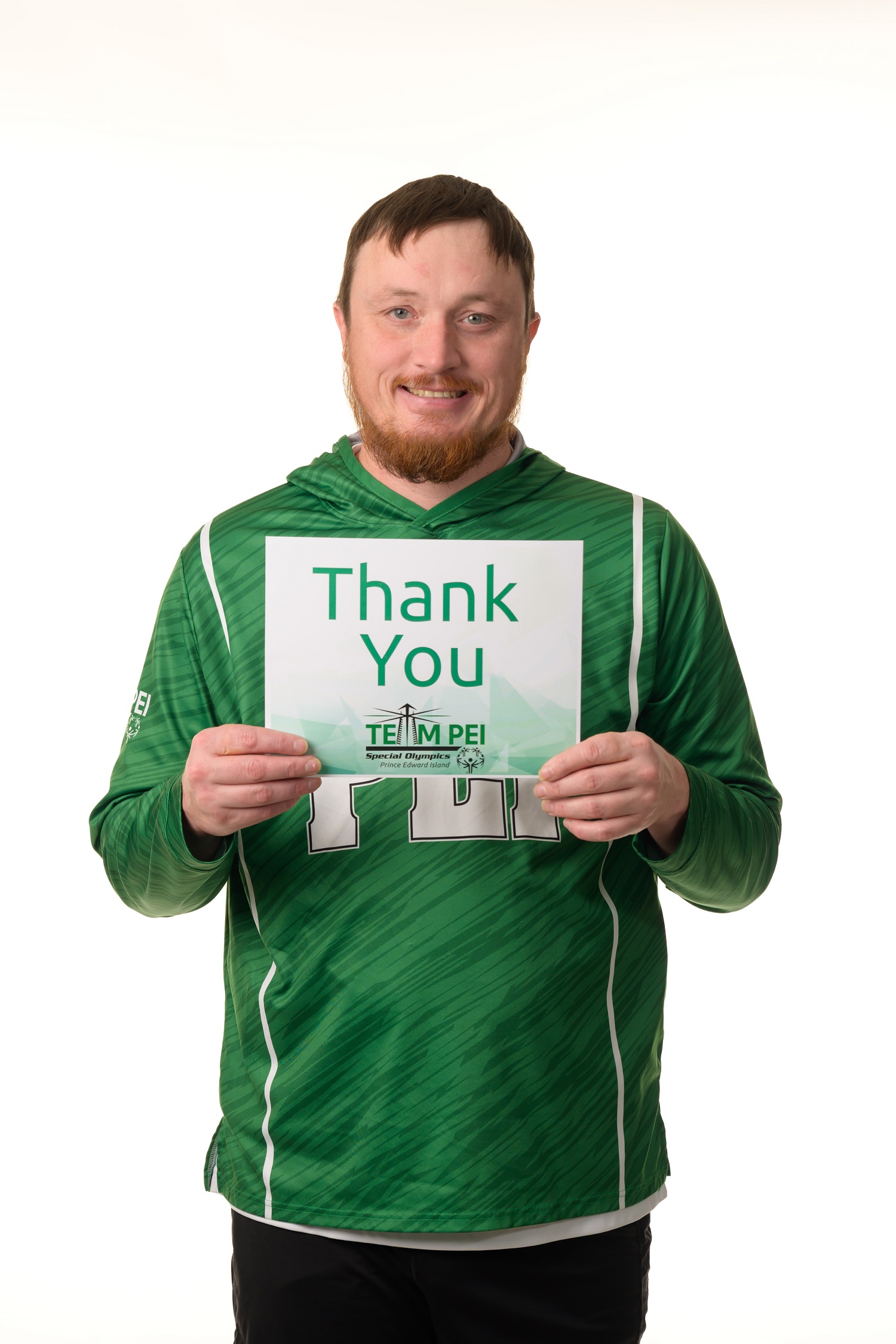 Team PEI 2026 Athletics athlete, Jeremy Wall, standing with a thank you sign Team PEI 2026 Athletics athlete, Jeremy Wall, standing with a thank you sign