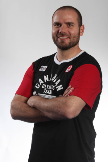 Portrait of a man with his arms crossed in a Team Canada Olympics tshirt. Portrait of a man with his arms crossed in a Team Canada Olympics tshirt.