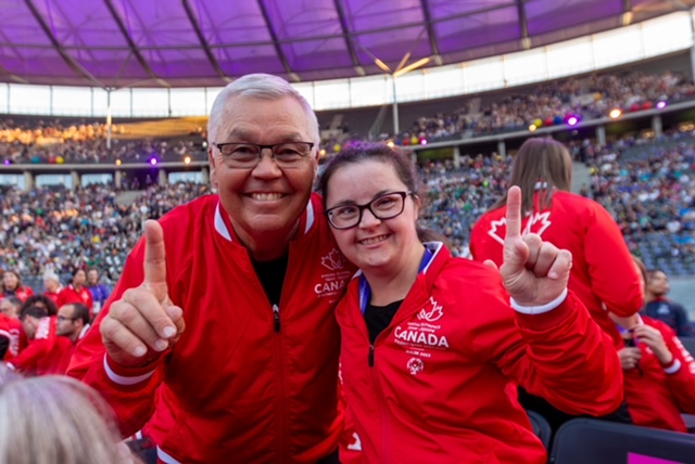 Allie Price, Empire Employee and Special Olympics Athlete, posing at an Special Olympics event with one other. 