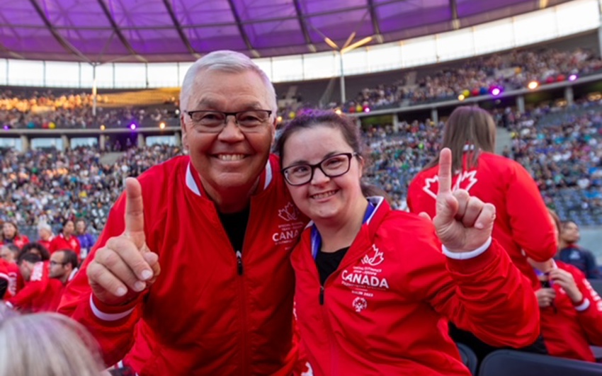 Allie Price, Empire Employee and Special Olympics Athlete, posing at an Special Olympics event with one other. 