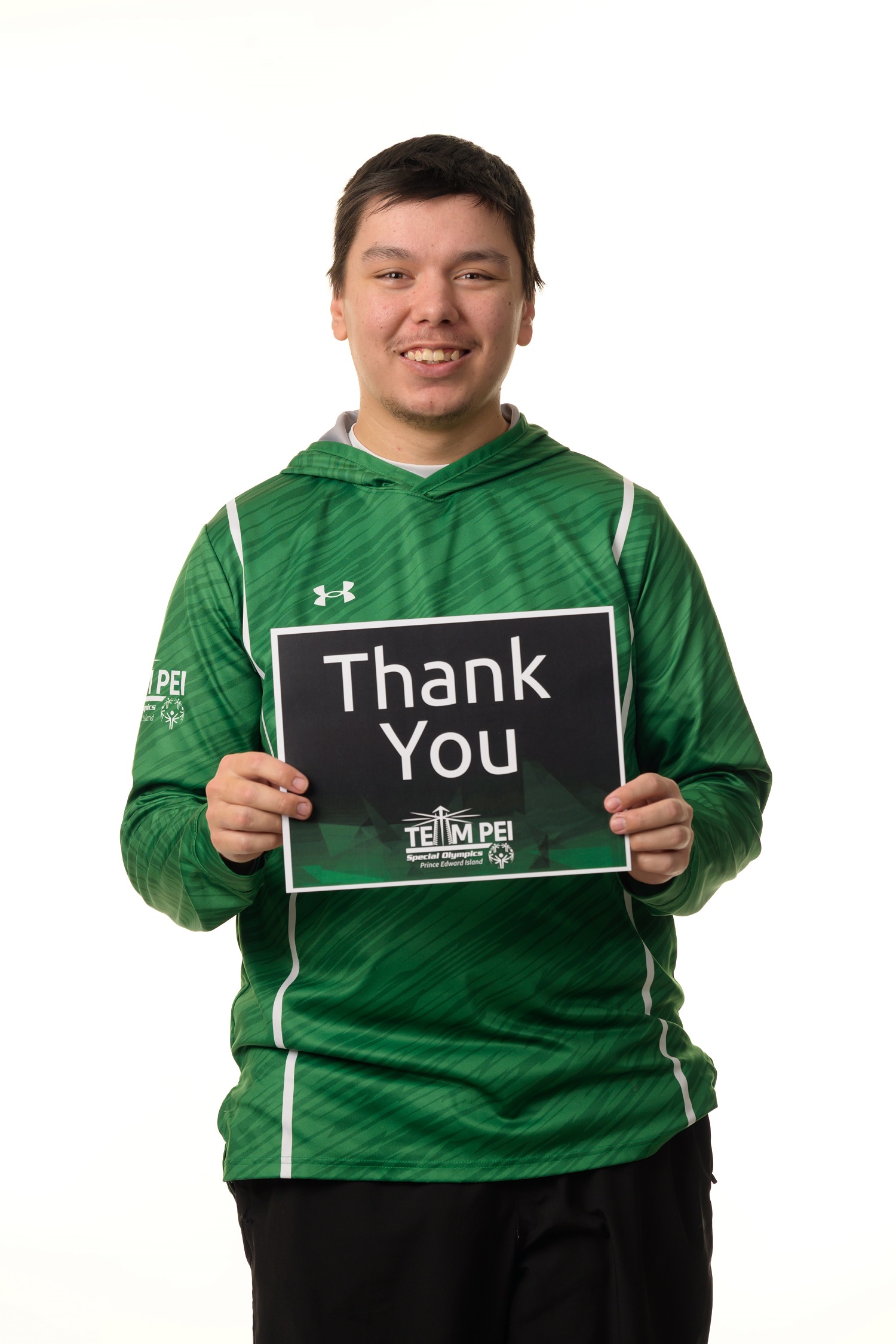 Team PEI 2026 Golf athlete, Matthew Jehn, standing with a thank you sign