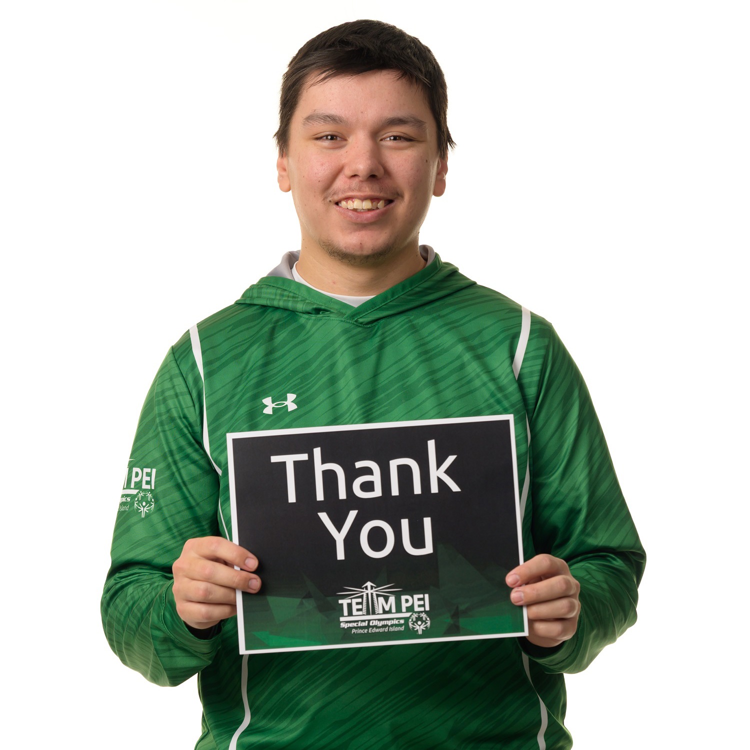 Team PEI 2026 Golf athlete, Matthew Jehn, standing with a thank you sign