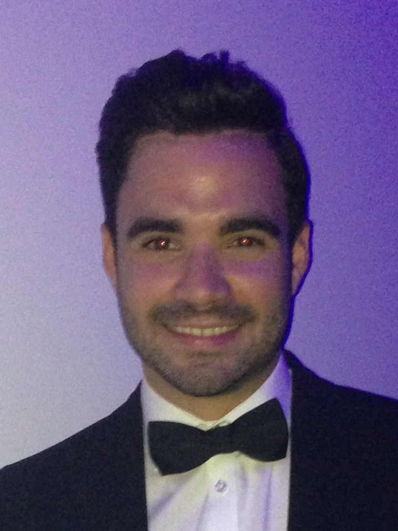 Headshot a man in a black jacket, white shirt and black bowtie. Headshot a man in a black jacket, white shirt and black bowtie.