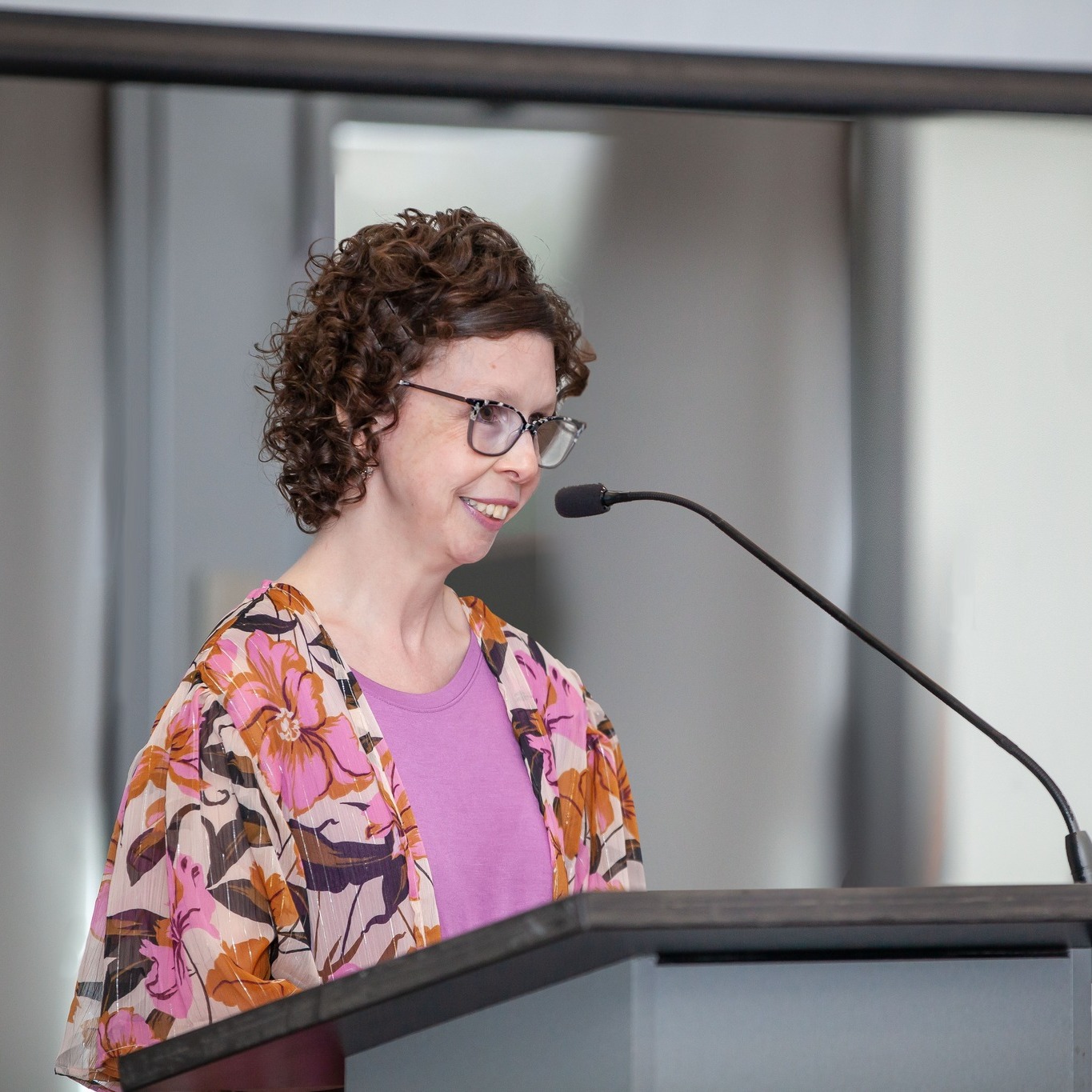 Athlete Leader, Emily Craig, speaking at a podium