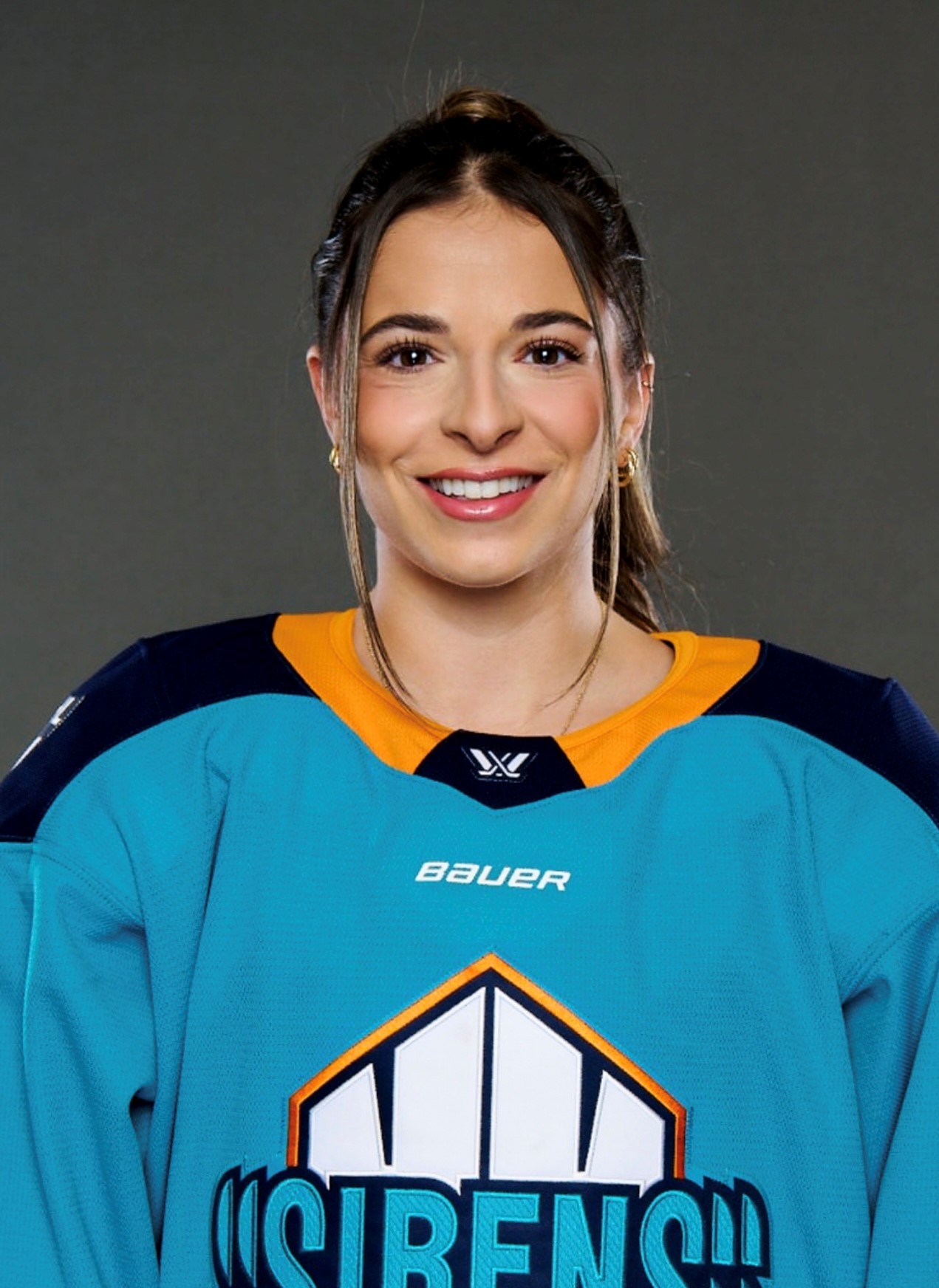 Headshot of a woman in a Sirens hockey jersey. Headshot of a woman in a Sirens hockey jersey.