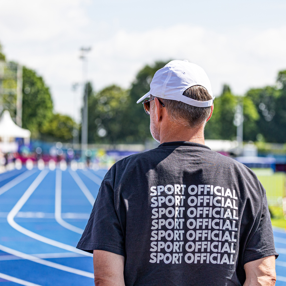 Man in black sport official shirt on a racetrack