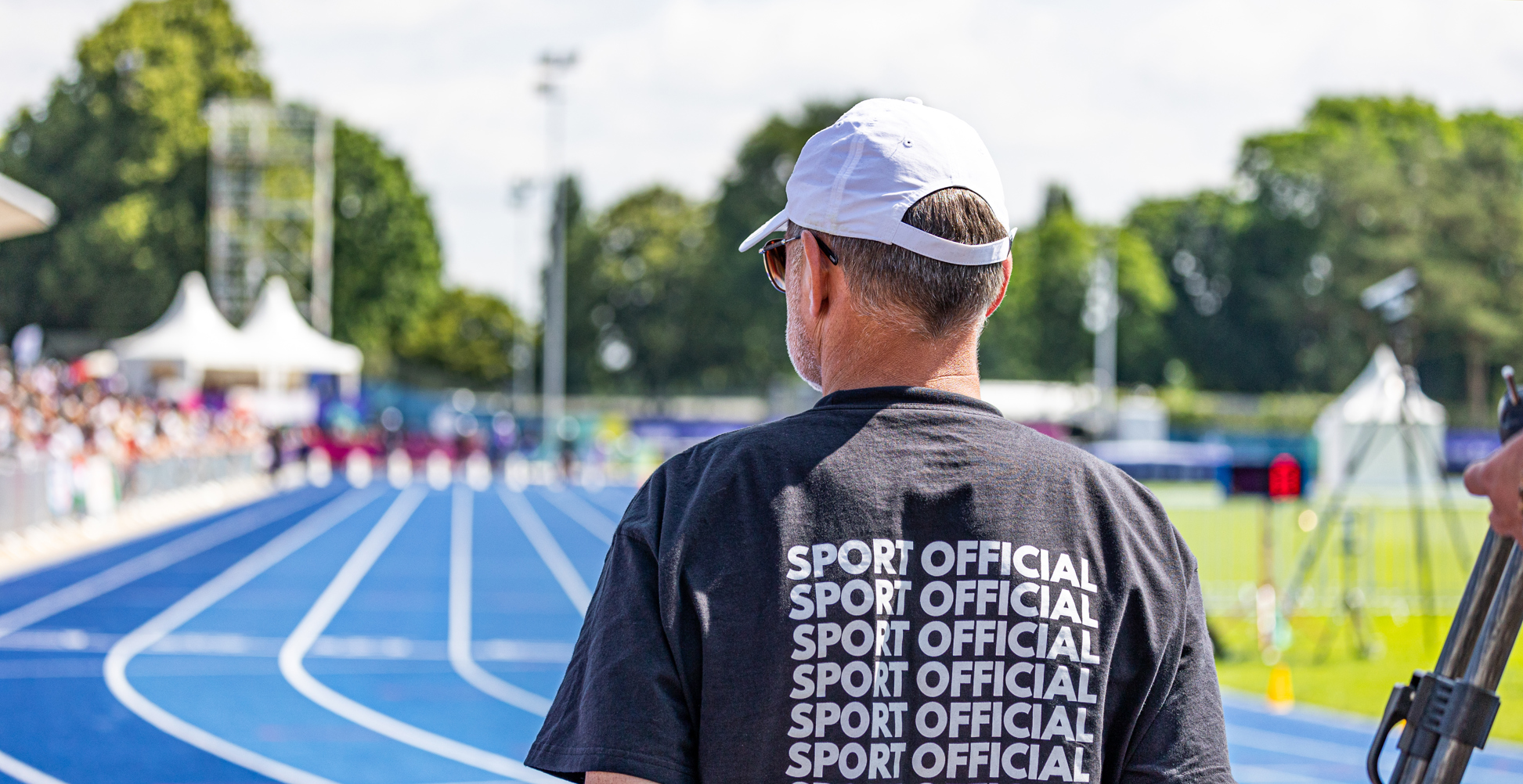 Man in black sport official shirt on a racetrack