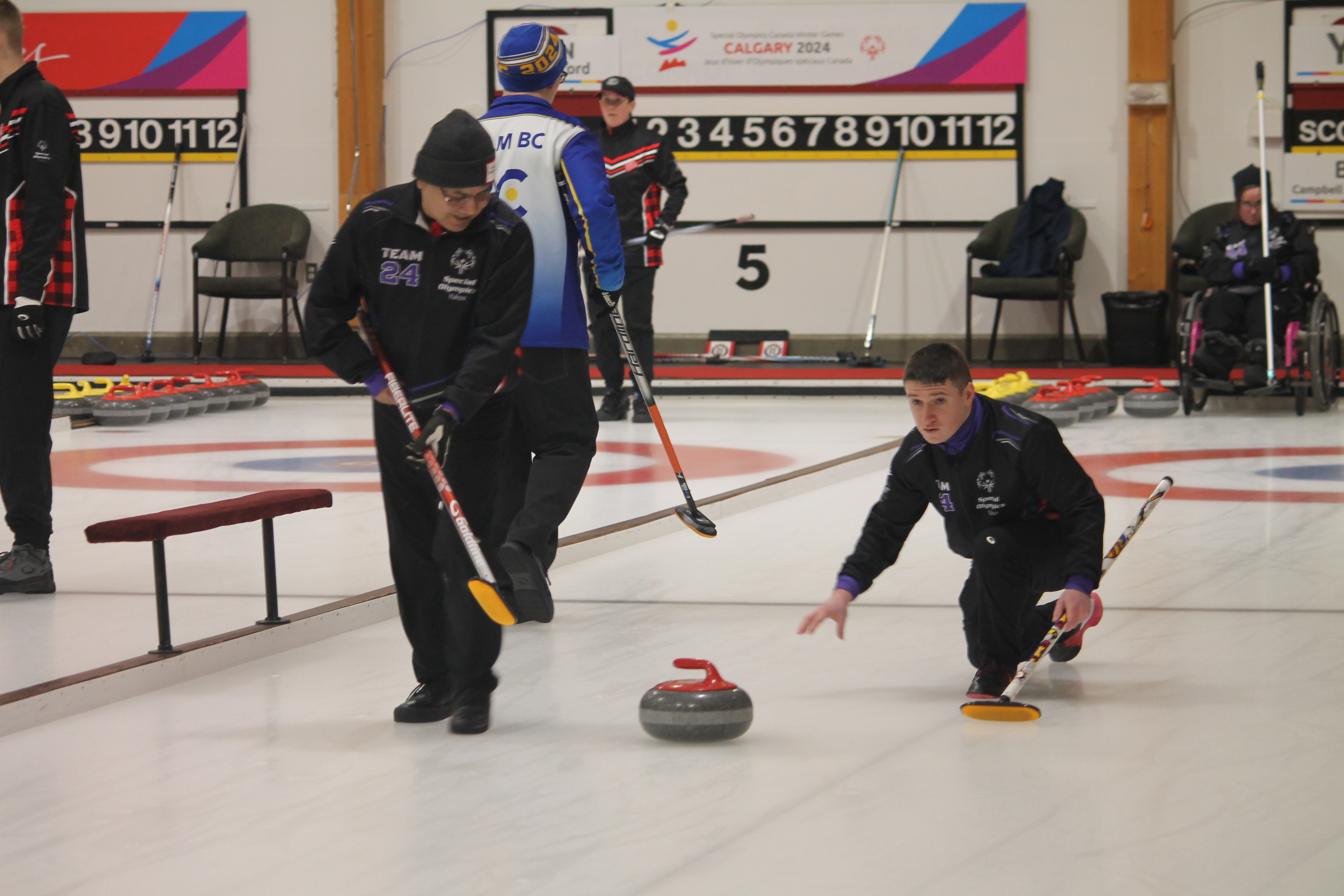 Brandle and a teammate participating in curling at a Special Olympics event. 