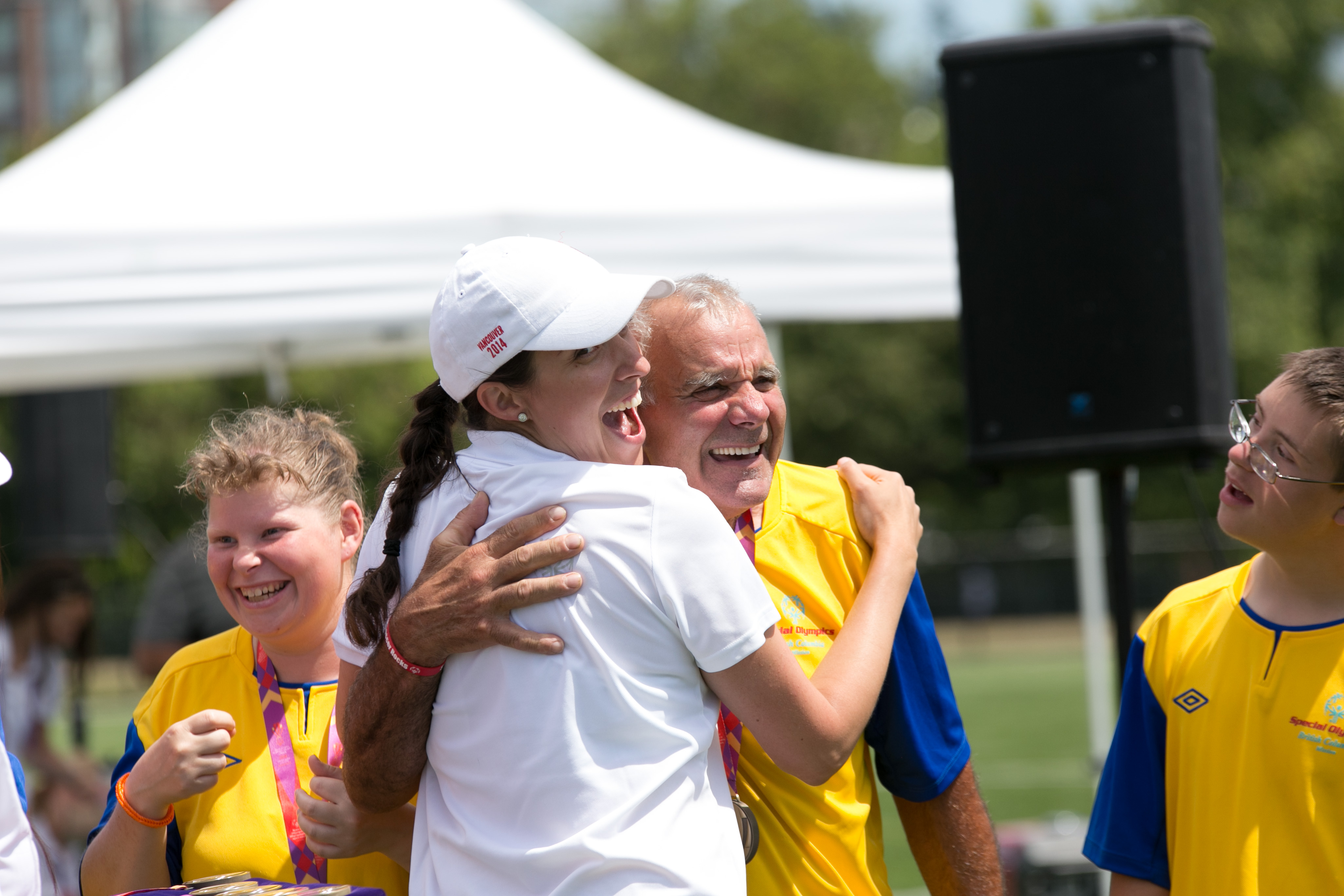 volunteer and athlete hugging