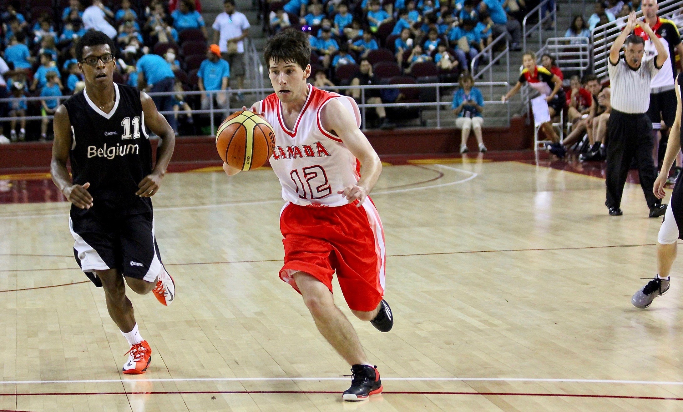 Matthew Williams runs with a basketball on the court