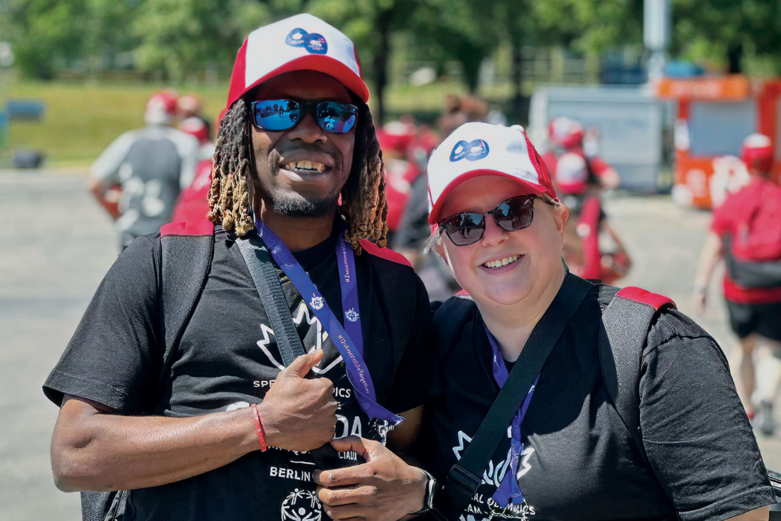 Special Olympics Team Canada athlete, Christian Gerro and his ASL interpreter, Erin Harper together in Berlin at the 2023 Special Olympics World Games