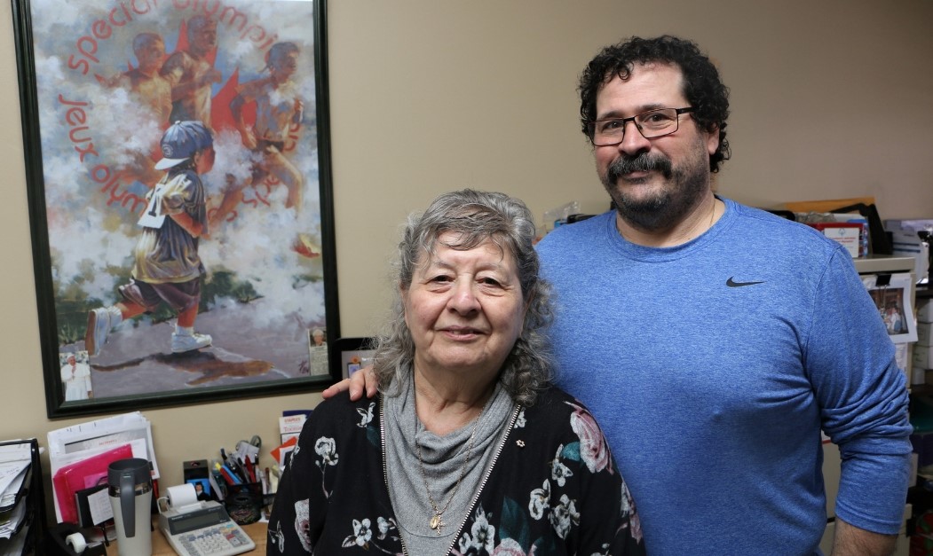 Dino and Susan Pedicelli pose for a photo in their Special Olympics home office.