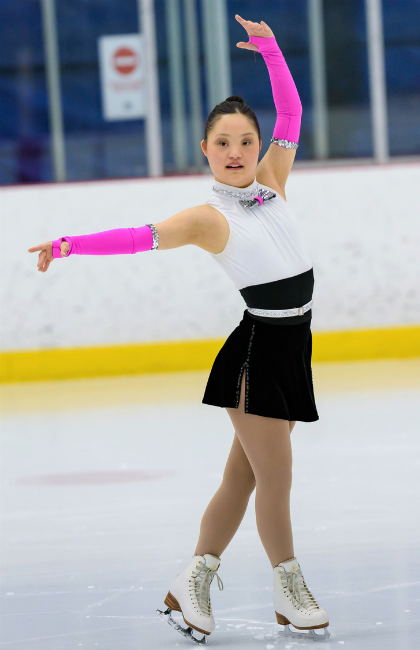 Special Olympics Alberta athlete Meg Ohsada poses on the ice.