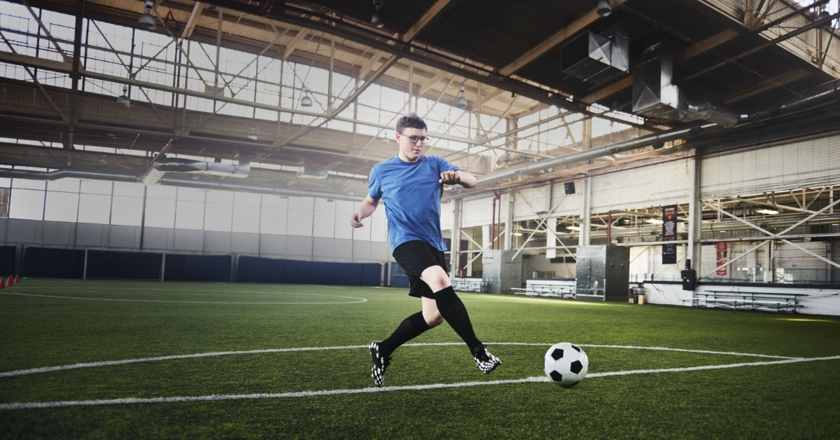 Photo of Mark Peddle, Newfoundland athlete and Sobeys employee kicking a soccer ball