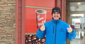Athlete Jesse Renouf smiling and standing in front of a Tim Hortons