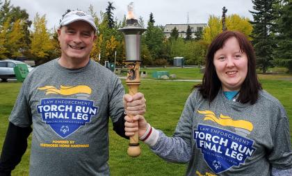 Grant and Gracie holding the torch