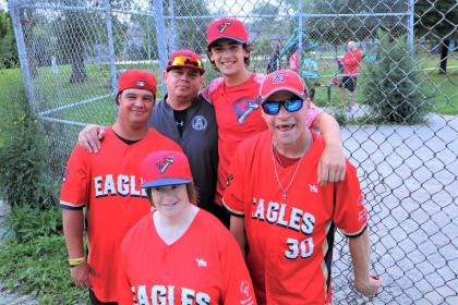 Coach Blake and some of his Etobicoke Eagles softball players pose for a photo.