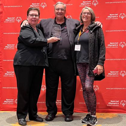 Clint Morrison holding award with family