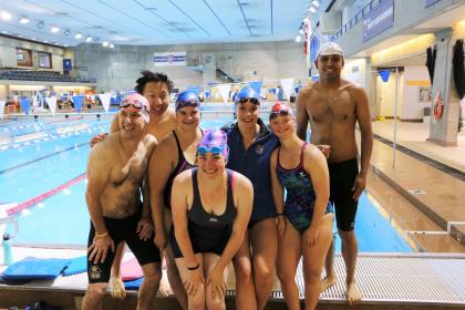 Penny Oleksiak poses for a photo with Special Olympics swimmers.