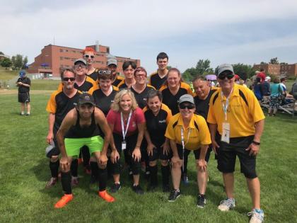 Olympic athlete Jennifer Jones poses for a photo with a Special Olympics team.