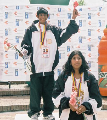 Natalie and Nerissa pose in track suits at a Special Olympics event