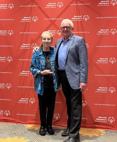 Vera Anderson holding award with Dan Howe