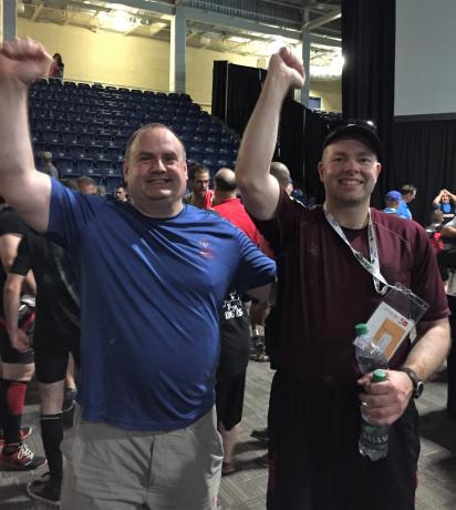 Jackie and Daniel Moores with arms raised after the Special Olympics 2018 Summer Games in Nova Scotia