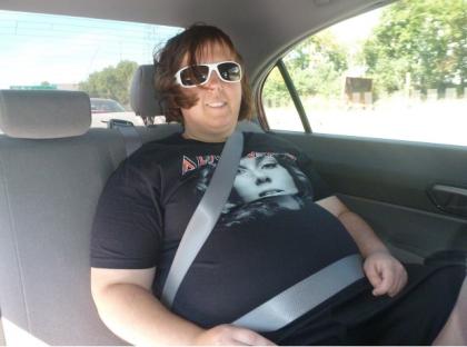 Lisa sits in a car, picture before her weightloss.