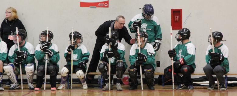 Special Olympics BC coach Richard offers a word of encouragement during a floor hockey tournament.