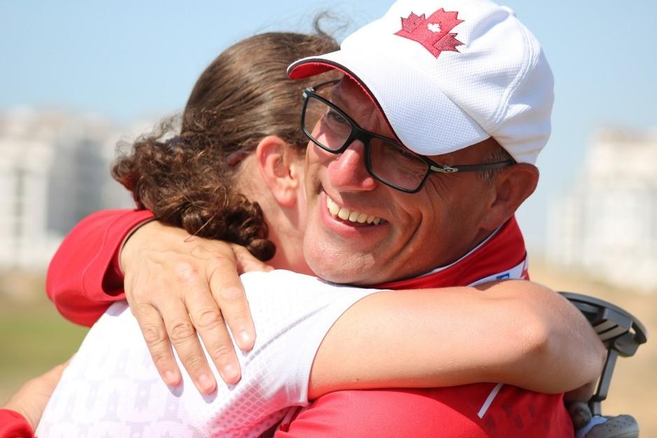 SO Team Canada head golf coach hugs one of his golfers.