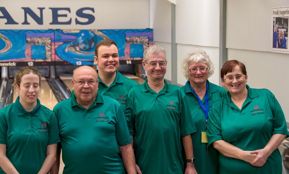 Maurice poses for a photo with his bowling team in front of the lanes