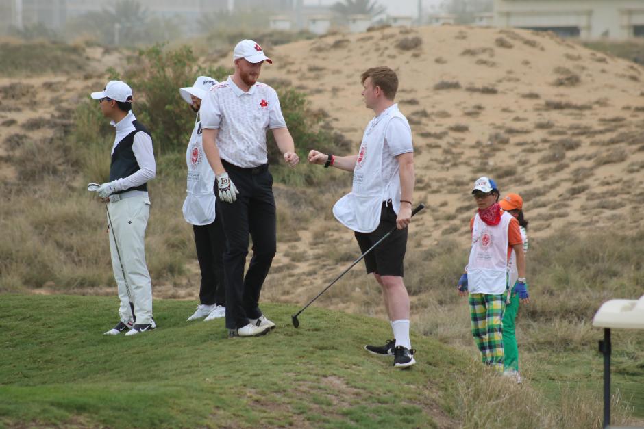 SO Team Canada golfer Jack and his brother Mitch Houlahan fist bump on the course.