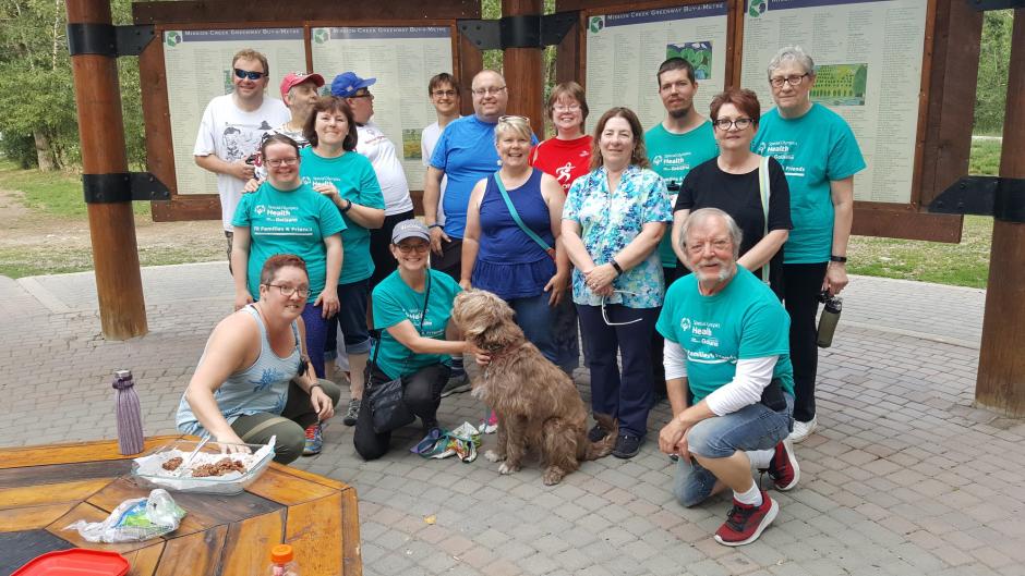 Special Olympics athletes, volunteers, and family members smile after a walk