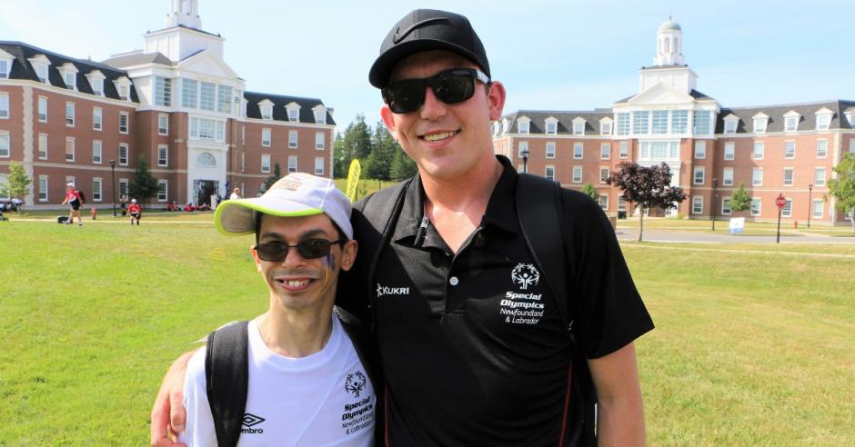 Andrew Hynes poses for a photo with his soccer coach Mike Beck.