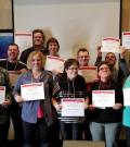 Athlete Leaders hold up certificates.