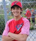 Coach Blake Fenwick poses for a photo at the baseball diamond.