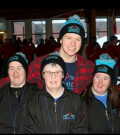 Logan Wilson poses for a photo with his arms around Special Olympics athletes.