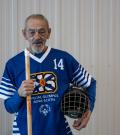 Richard Myette poses with his floor hockey stick looking into the camera