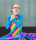 Jordyn Flamma spins on the ice in her rainbow dress.