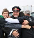 Sgt. Joe Tataryn in his police uniform as Special Olympics athletes give him a group hug.