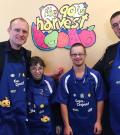 Braylon poses for a photo at Cora's restaurant for a Cops and Crepes event with another officer and two Special Olympics athletes