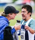 Kyla and a Special Olympics athlete hug at an event