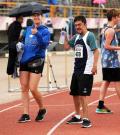 Kyla on the track with a Special Olympics athlete.