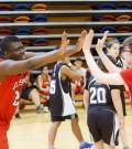 Athletes high five at a ASAA Unifed Sport event