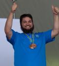 Daniel Thomas smiling with thumps up and medals around his neck